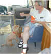 Penny begging a fry from Michael. Notice the HT set up for APRS on the dash of the RV.