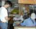 Barry, one of the owners of the Malanda's Wood Camp watches while Janee works some stations for Field Day.