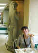Janee enjoying her spinach and tomato pizza at Ray Bari's as she is watched by David there in the background. <g>