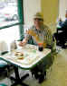 Michael eating a garlic roll at Ray's